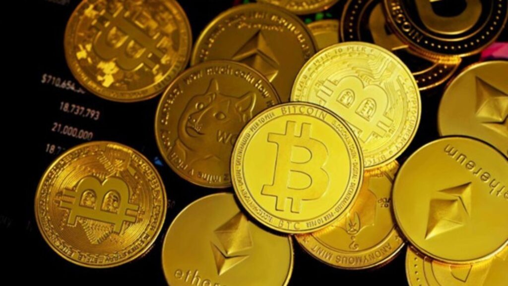 Gold bitcoins on a black surface.